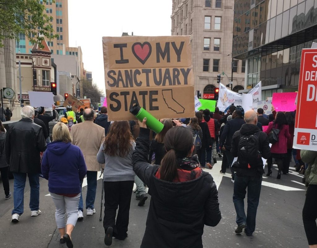 Marchers in Sacramento protest Trump administration immigration policies. Photo by Trevor Eischen for CALmatters