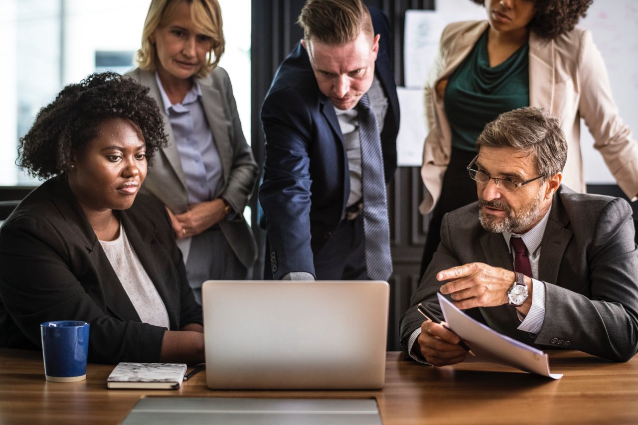 Women and men gathering at a business meeting. California is pushing for women in boardrooms.