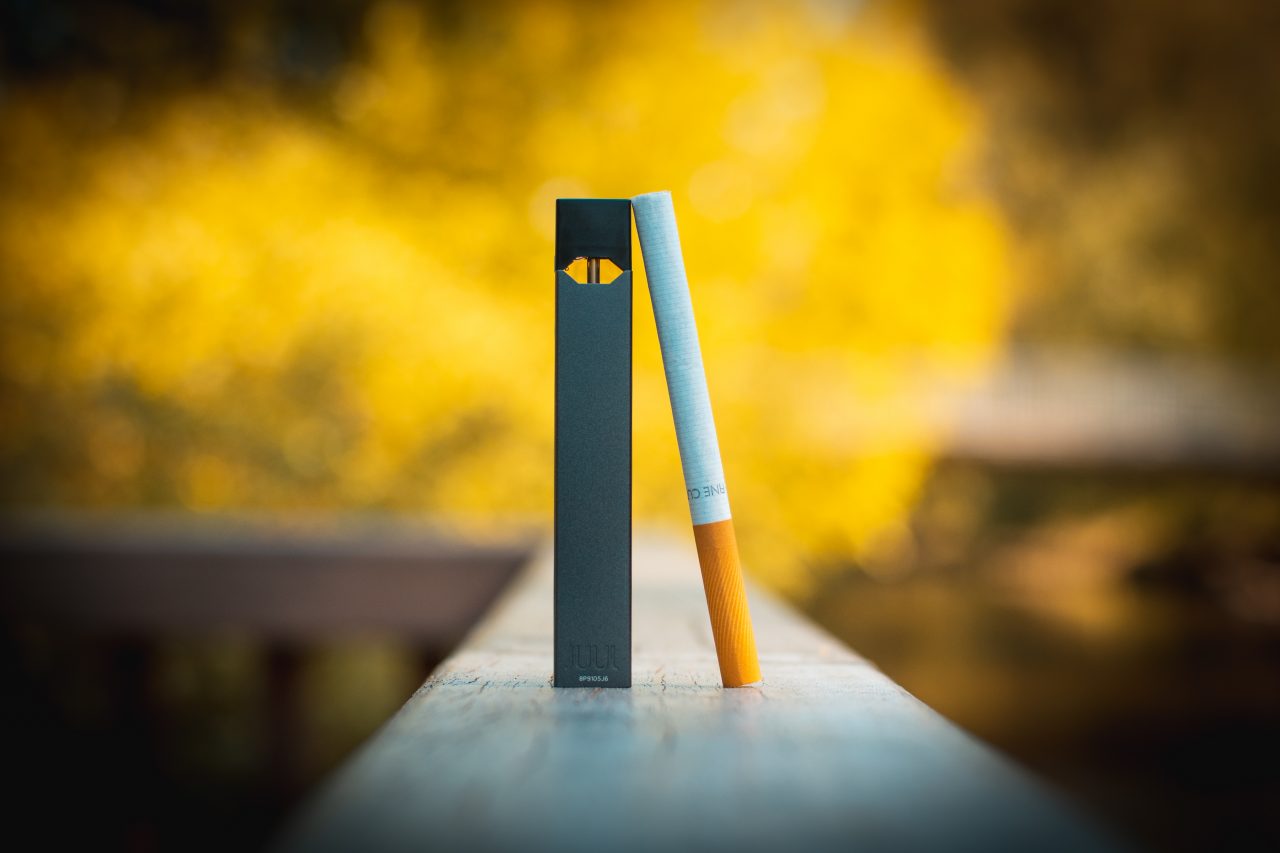 A JUUL e-cigarette, left, and a regular cigarette. Flickr photo courtesy of vaping360.com