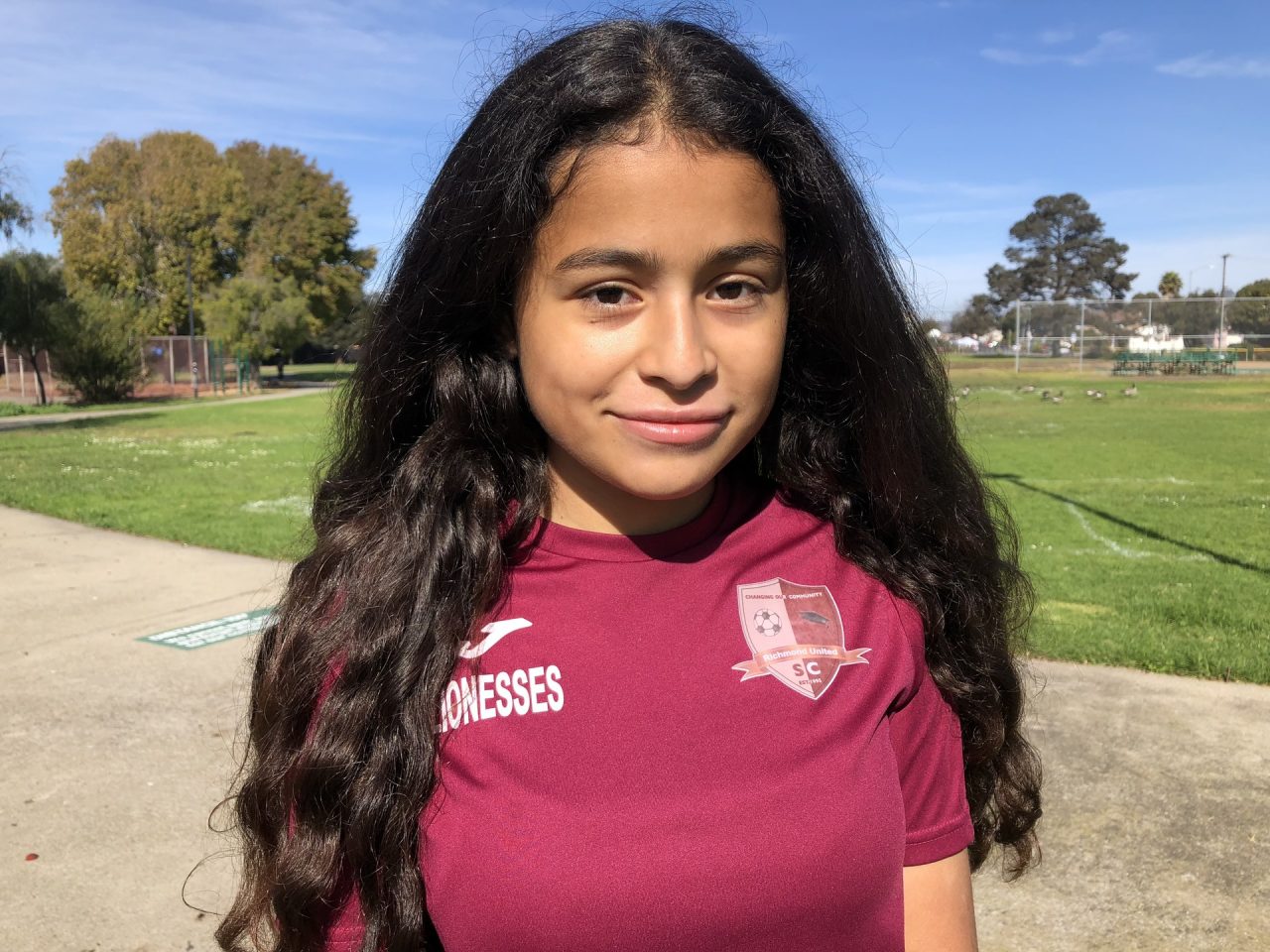 Crista Ramos, 14, stands at a park in Richmond after a soccer match on Nov. 4, 2018. "I felt like I needed to speak up... and represent all the children whose parents have TPS and could be sent back," said Crista of why she is suing the federal government. Photo for CALmatters by Farida Jhabvala Romero/KQED