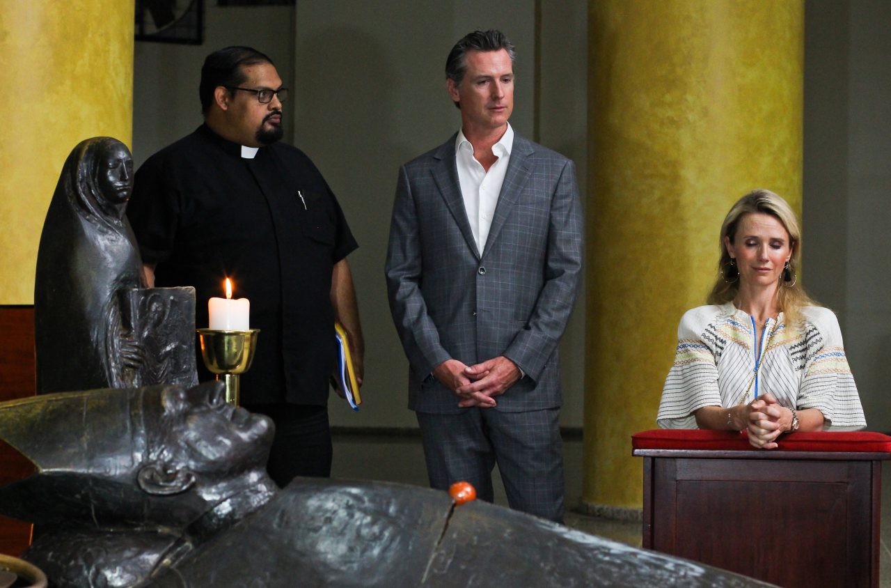 Gov. Gavin Newsom with his wife, Jennifer Siebel Newsom, visit the tomb of Archbishop Oscar Romero at Metropolitan Cathedral in San Salvador, El Salvador, AP Photo/Salvador Melendez, Pool