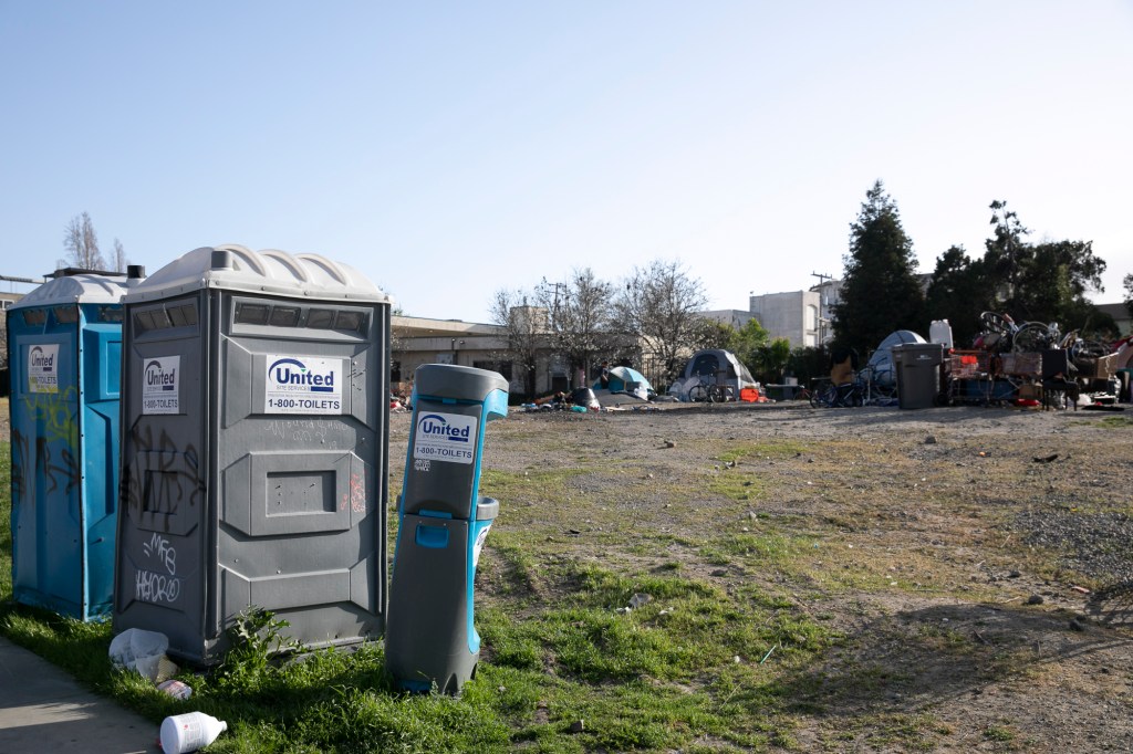 A hand sanitizing station at a homeless encampment near Oakland city hall. Photo by Anne Wernikoff for CalMatters