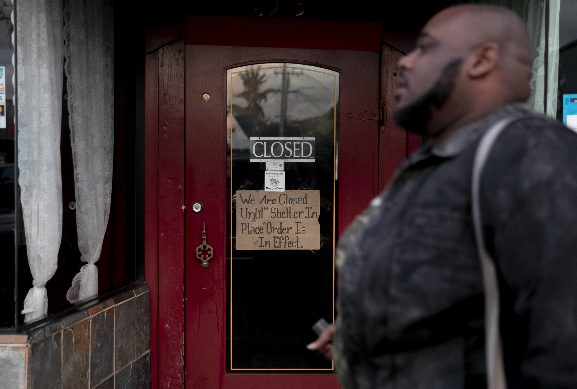 A sign attached to a restaurant door in the Temescal neighborhood of Oakland alerts customers that it will remain closed during the ‘shelter in place’ mandated for six Bay Area counties on March 16, 2020.