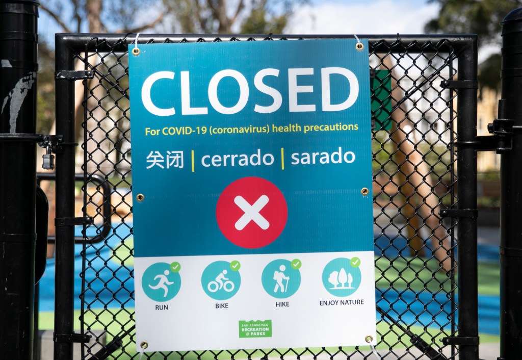 A locked playground gate in San Francisco. Following an influx of park-goers over the weekend, Gov. Gavin Newsom has closed parking lots at state parks across the state in an effort to limit to spread of COVID-19. Photo by Anne Wernikoff for CalMatters