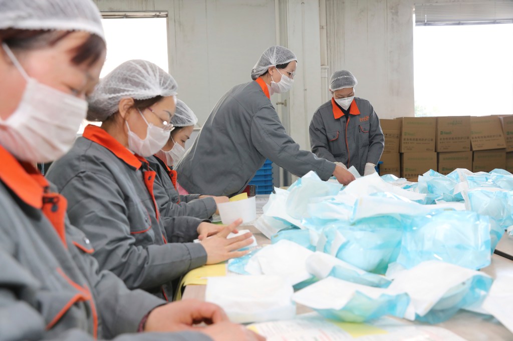 Feb. 20, 2020, workers pack N95 respirators in a medical supply factory in Nantong in east China's Jiangsu province. Today, Gov. Gavin Newsom announced that California will receive 200 million masks per month from unspecified suppliers in Asia in order to meet state needs during the COVID-19 crisis. Photo by FeatureChina via AP Images
