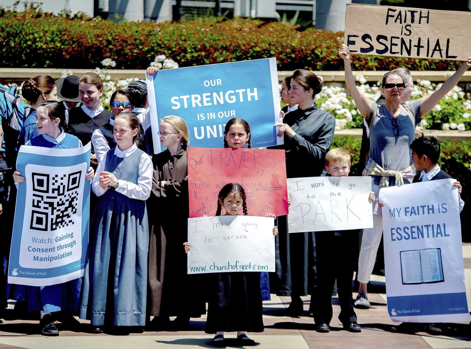 Young members of the Church of God in Rancho Cucamonga demonstrate against California Gov. Gavin Newsom's stay-at-home orders amid the coronavirus outbreak. Newsom has been forced to respond to defiant counties and churches as he slowly lifts restrictions. Photo by Watcher Phomicinda/The Orange County Register via AP