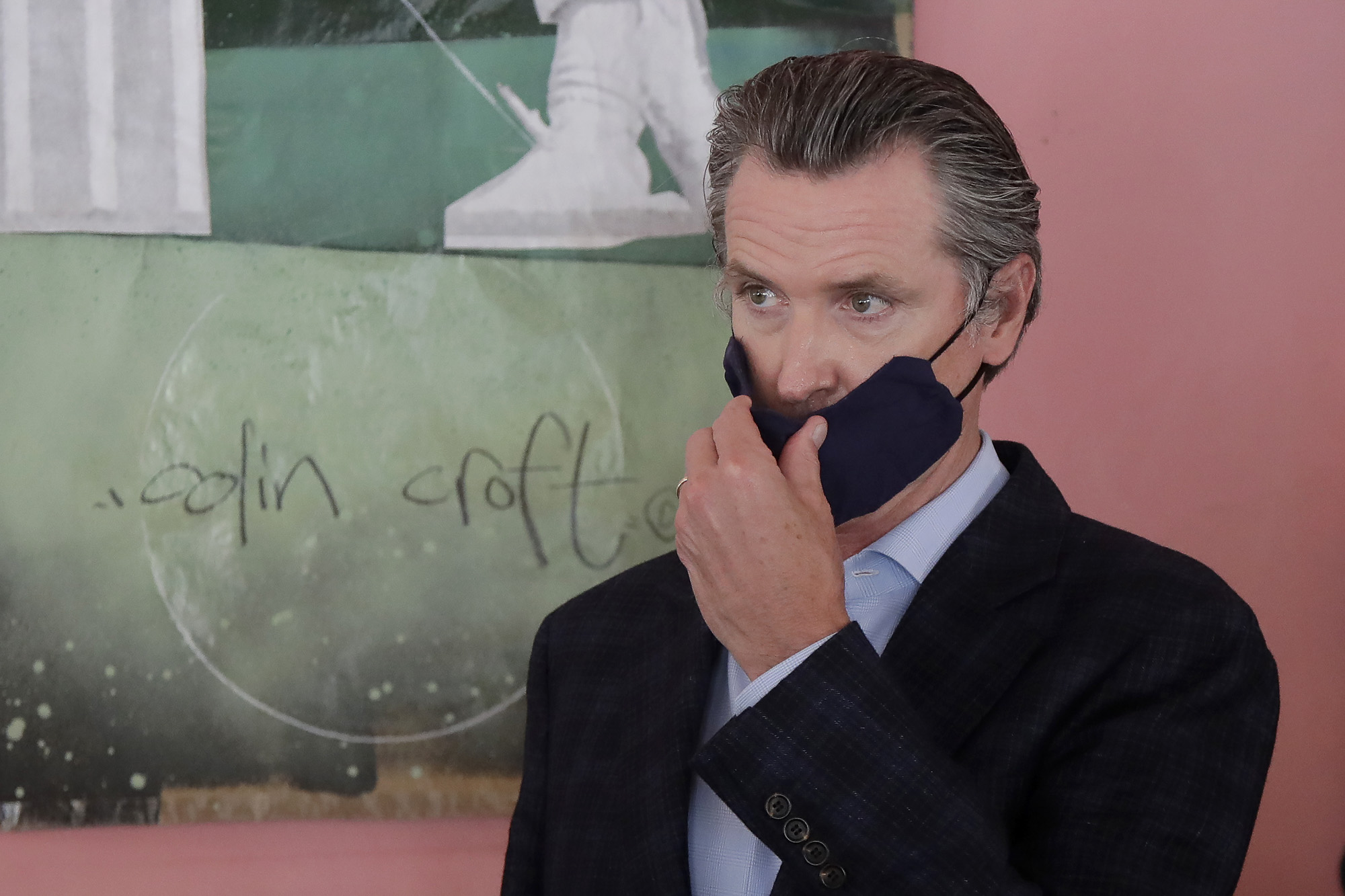 Gov. Gavin Newsom wears a protective mask on his face while speaking to reporters at Miss Ollie’s restaurant during the coronavirus outbreak in Oakland, Calif., Tuesday, June 9, 2020. (AP Photo/Jeff Chiu, Pool)
