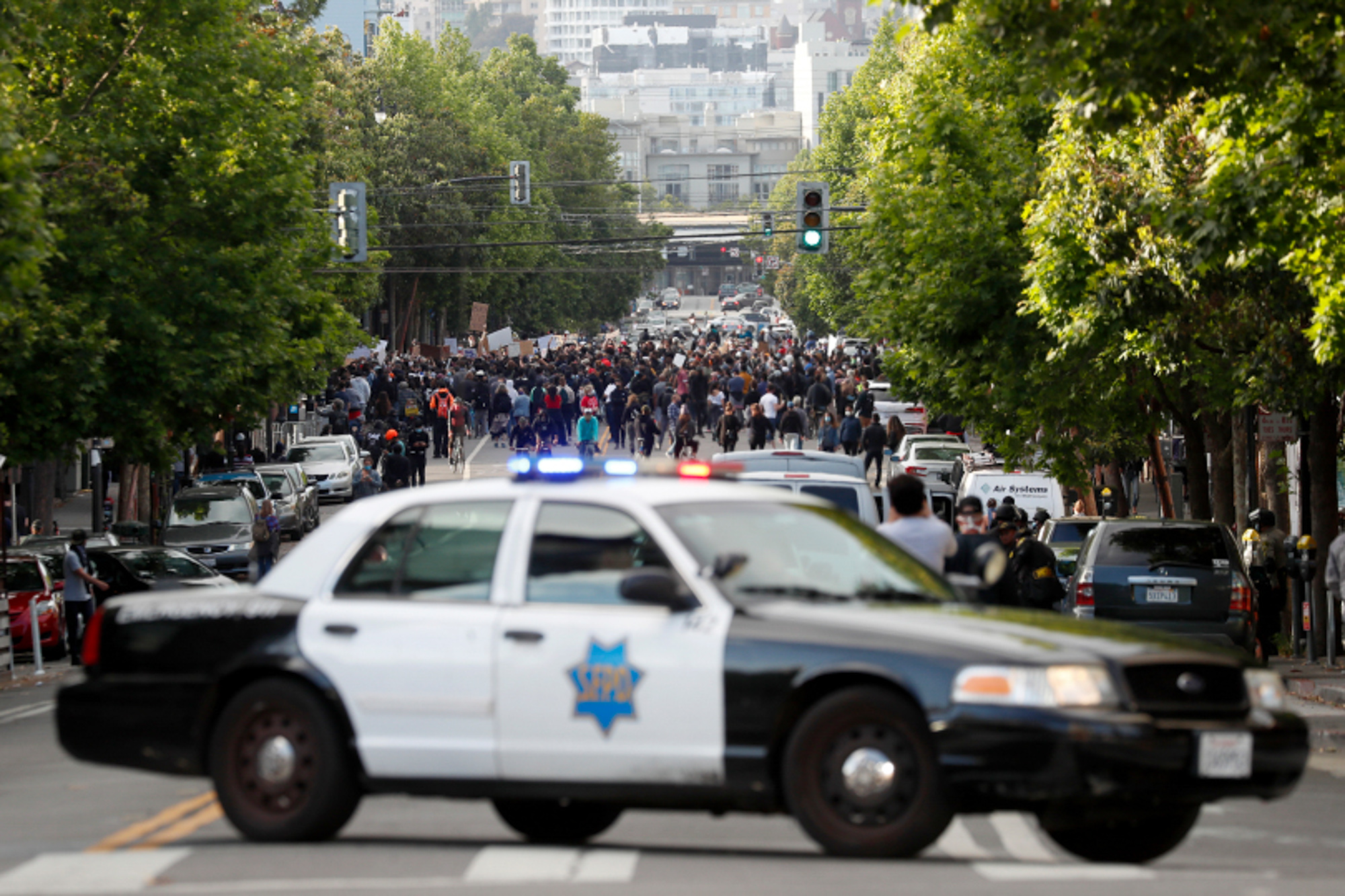 A patrol car closes off Valencia Street in San Francisco after a group of protesters gathered in front of the Mission Police Station on May 30, 2020, the second day of Bay Area unrest over the George Floyd killing in Minneapolis. Later in the year, lawmakers approved two new laws that aim to improve policing. Photo by Karl Mondon, Bay Area News Group