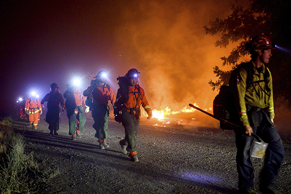 Inmate firefighters, left, battle the Quail Fire burning near Winters, Calif., on Sunday, June 7, 2020. Photo by Noah Berger, AP Photo
