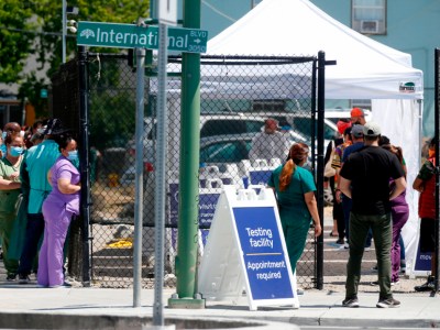 People wait in line at a Covid-19 testing facility sponsored by the Native American Health Center on International Boulevard near 31st Avenue in Oakland on July 7, 2020. Photo by Jane Tyska, Bay Area News Group
