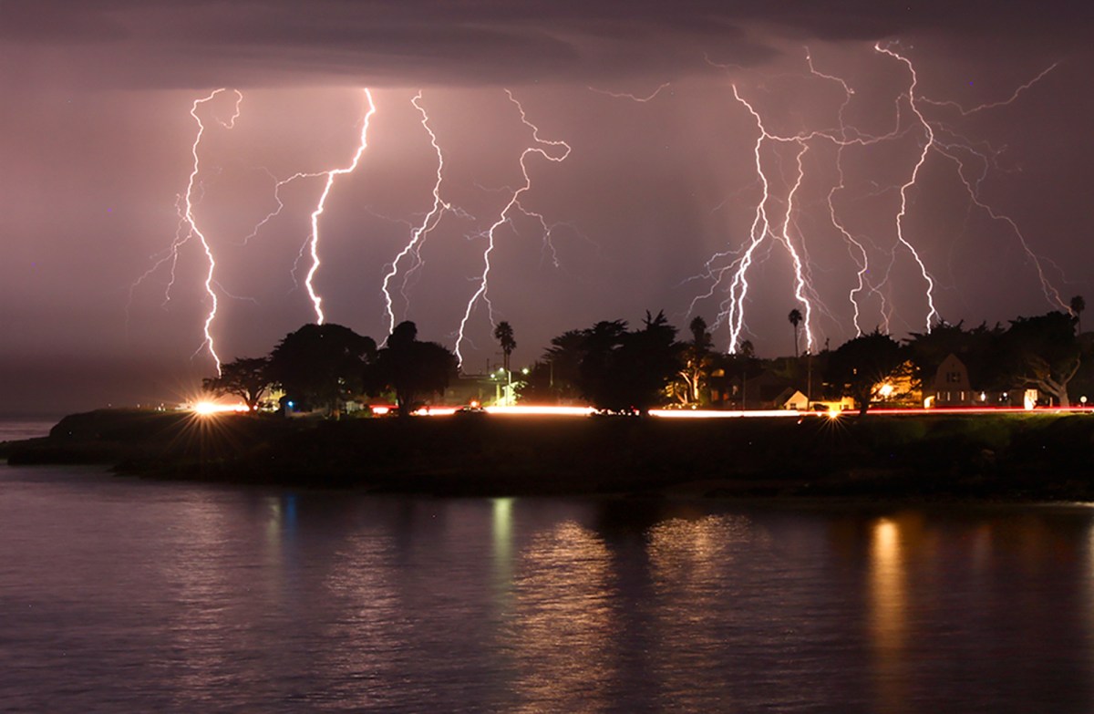 A rare lightning storm crackles over Mitchell's Cove in Santa Cruz around 3 a.m. August 16, 2020. The severe storm system rolled through the San Francisco and Monterey Bay areas early Sunday, packing a combination of dry lightning and high winds that triggered wildfires throughout the region. The National Weather Service on Sunday extended a red flag fire warning for the entire Bay Area until 11 a.m. Monday morning. Photo by Shmuel Thaler, The Santa Cruz Sentinel via AP