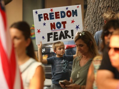 Johnny Grandstaff, 8, of Durham Elementary, holds up a sign he made with his mom, saying, "Freedom not fear!" in Chico, during a rally demanding that Butte County reopen on Oct. 2, 2020. Photo by Carin Dorghalli, Enterprise-Record