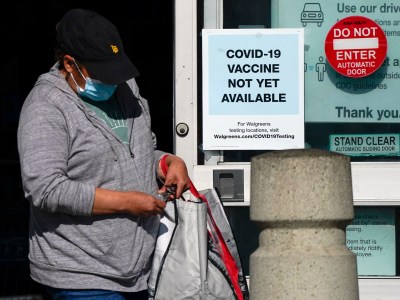 A customer walks past a sign indicating that a COVID-19 vaccine is not yet available at Walgreens on Dec. 2, 2020, in Long Beach. Photo by Ashley Landis, AP Photo