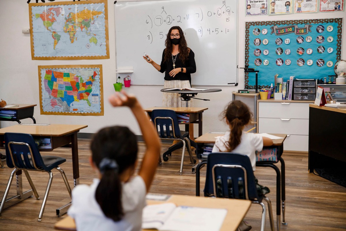 Second and third grade teacher Kylie Shannon, center, answers questions from students during the first day of school at Sunnyvale Christian School in Sunnyvale on Aug. 27, 2020. Photo by Randy Vazquez, Bay Area News Group