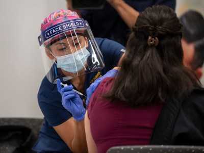 Registered Nurse Reanne Takara administers the Pfizer COVID-19 vaccine to frontline health workers at UC Davis Medical Center on Dec. 15, 2020. Photo courtesy of UC Davis Health