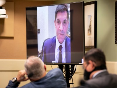 Assemblymembers listen as Faiz Ahmad, Bank of America managing director of transaction services, makes opening comments during a budget subcommittee hearing on unemployment insurance on Jan. 26, 2020. Photo by Anne Wernikoff, CalMatters