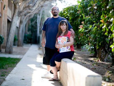 Stacy Lira and her husband, Armando, outside of their home in Victorville on March 29, 2021. Photo by Shae Hammond for CalMatters
