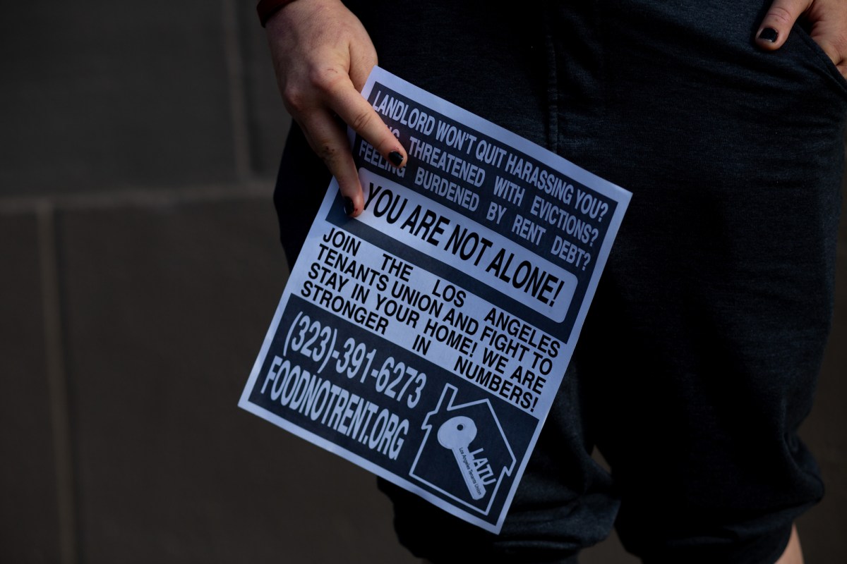 Jordan Lyric holds a rent strike poster in Los Angeles on May 6, 2021. Photo by Shae Hammond for CalMatters