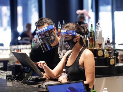Bartenders were masks and face shields as they work at Slater's 50|50 on July 1, 2020, in Santa Clarita. Photo by /Marcio Jose Sanchez, AP Photo