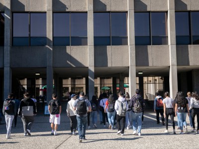 Students walk across campus at California State University East Bay. Photo by Anne Wernikoff for CalMatters