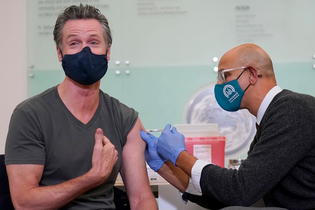 Gov. Gavin Newsom, left, received a Moderna COVID-19 vaccine booster shot from California Health and Human Services Secretary Dr. Mark Ghaly at Asian Health Services in Oakland on Oct. 27, 2021. Photo by Jeff Chiu, AP Photo