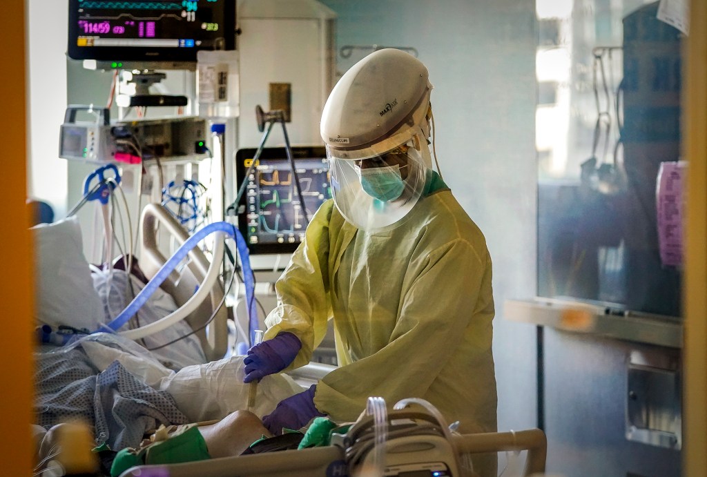 A healthcare worker tends to a COVID-19 patient in the intensive care unit at Santa Clara Valley Medical Center in San Jose on Jan. 13, 2021. AP Photo/Jeff Chiu