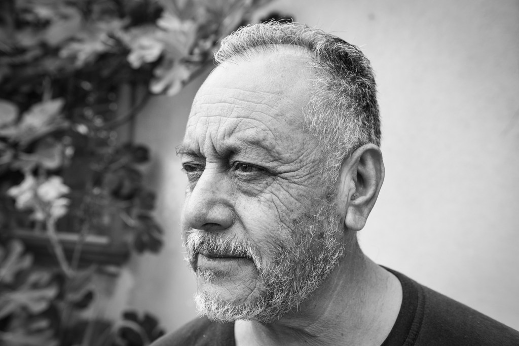 Javier Beltrán in front of his home in Wilmington's Figueroa Place on July 26, 2021. According to Beltrán, he worked at the nearby refineries throughout his life. "It was a good job, obviously, but it also had its bad sides," Beltrán said. "The pollution and everything that exists inside [the refineries] the bad odors, and all of the toxins that people are exposed to." After working that job for nearly 10 years, Beltrán says that he eventually left because he noticed a decline in his health. "Before I used to run, and over time I found myself not being able to do it anymore without breathing so heavily." Photo by Pablo Unzueta