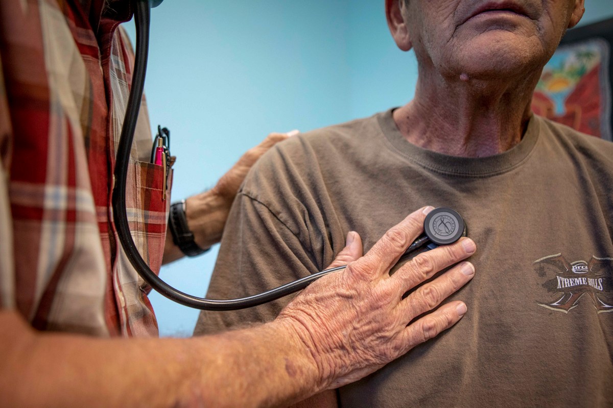 A doctor listens to a man's heart beat at a clinic in Bieber on July 23, 2019. Photo by Anne Wernikoff for CalMatters