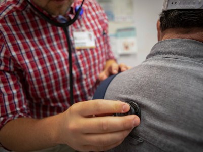 A physician assistant tends to a patient at a clinic in Bieber on July 23, 2019. Photo by Anne Wernikoff for CalMatters