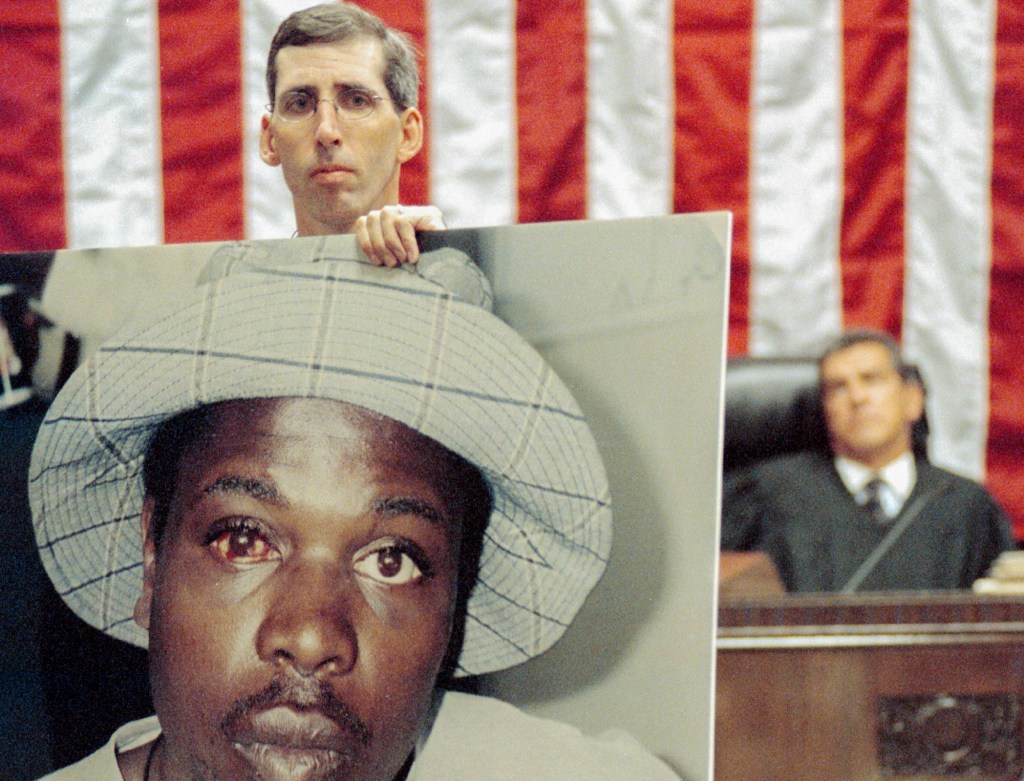 Assistant District Attorney David Hollister shows a photograph of Delphine Allen in Alameda County Superior Court in Oakland on Sept. 12, 2002. Allen was beaten on June 20, 2000 by former Oakland Police officers known as the Riders. Photo by Ray Chavez, Oakland Tribune via Bay Area News Group