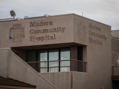 The outline of the Madera Community Hospital sign and crest on the main buildings of the hospital on Jan. 2, 2023. The sign was removed after the hospital announced its closure due to bankruptcy pushing the county into a state of emergency. Photo by Larry Valenzuela, CalMatters/CatchLight Local