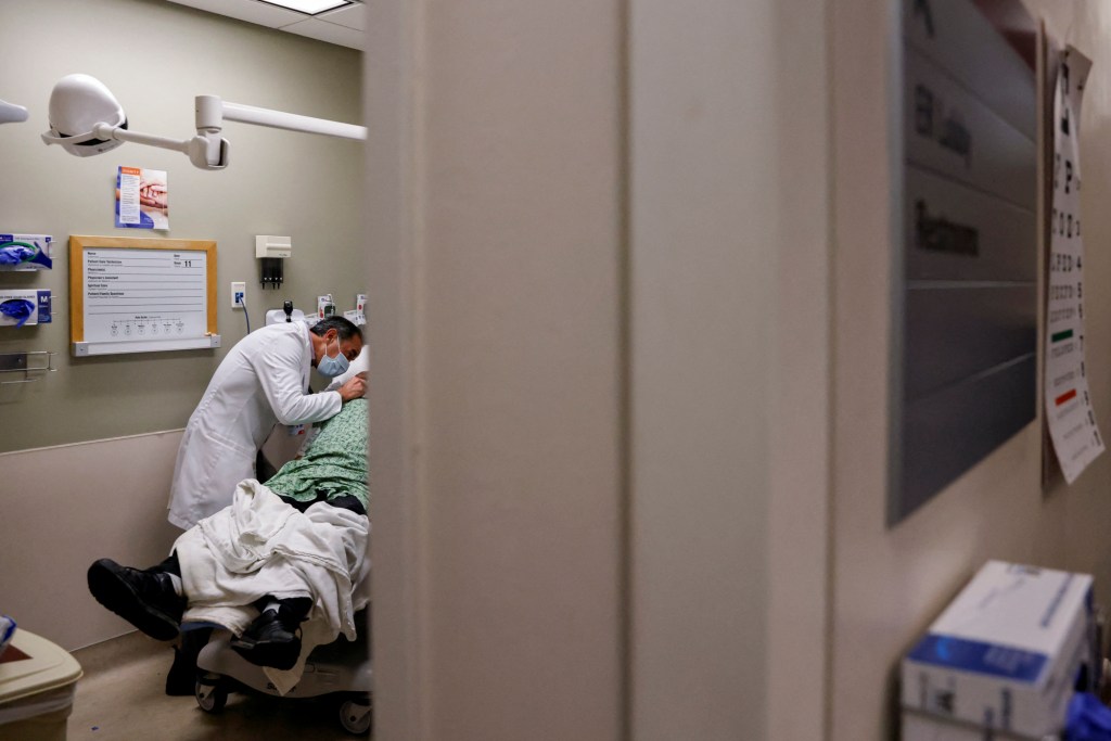 Emergency room doctor Jim Keany treats patient a in the Emergency room at Providence Mission Hospital in Mission Viejo on Jan. 27, 2022. Photo by Shannon Stapleton, Reuters