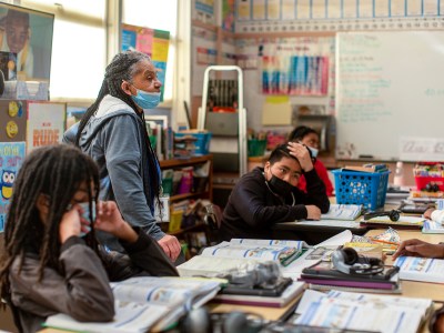 Theresa Griffin helps students with their class work on Feb. 6, 2023. Photo by Shelby Knowles for CalMatters