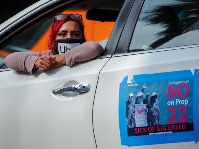 App-based gig worker Terresa Mercado participates in a demonstration outside Los Angeles City Hall to urge voters to vote no on Proposition 22 in Los Angeles on Oct. 8, 2020. Photo by Mike Blake, Reuters