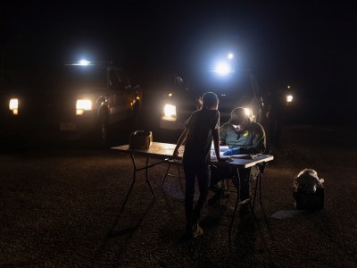 An unaccompanied migrant child seeking asylum, is registered by a border patrol agent after she crossed the Rio Grande river from Mexico into Roma, Texas on May 14, 2022. Photo by Adrees Latif, Reuters