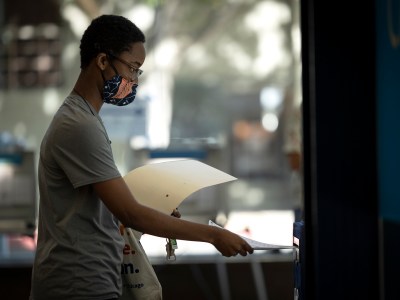 A voter casts their ballot at a voting site at the California Museum in downtown Sacramento on June 7, 2022. Photo by Miguel Gutierrez Jr., CalMatters