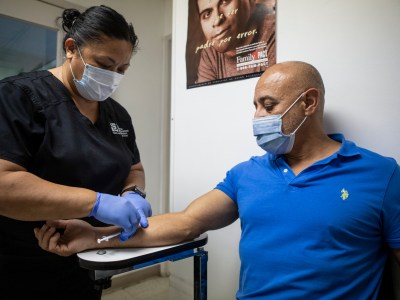 Fresno resident Gonzalo Garcia receives the monkeypox vaccine on Aug. 24, 2022. Photo by Larry Valenzuela, CalMatters/CatchLight Local
