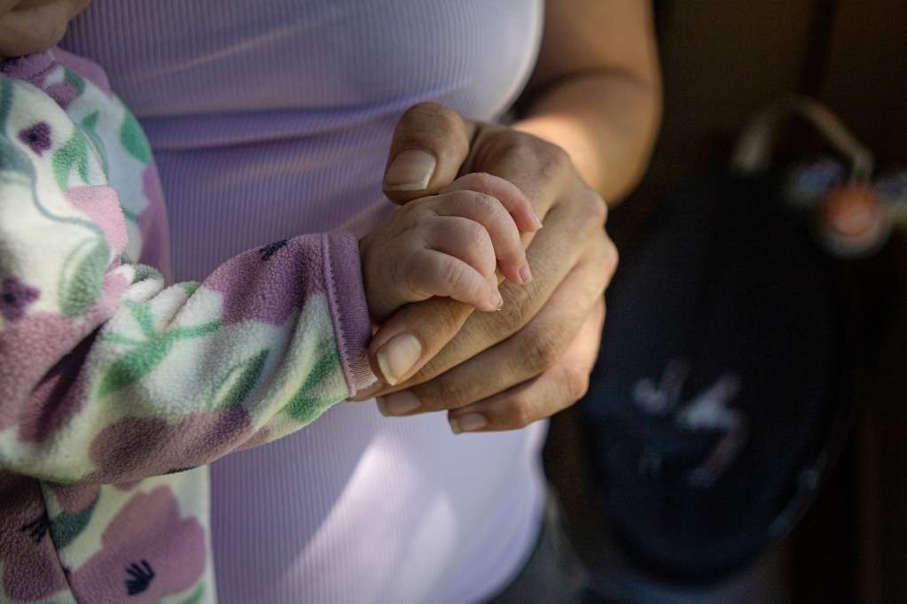 A mother holds her child in her apartment in Redding on Sept. 20, 2022. Photo by Larry Valenzuela, CalMatters/CatchLight Local