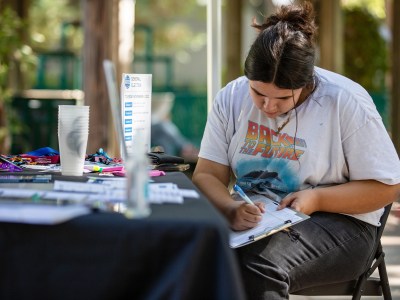 A student registers to vote at Sacramento State University in Sacramento on Oct. 20, 2022. Photo by Rahul Lal, CalMatters