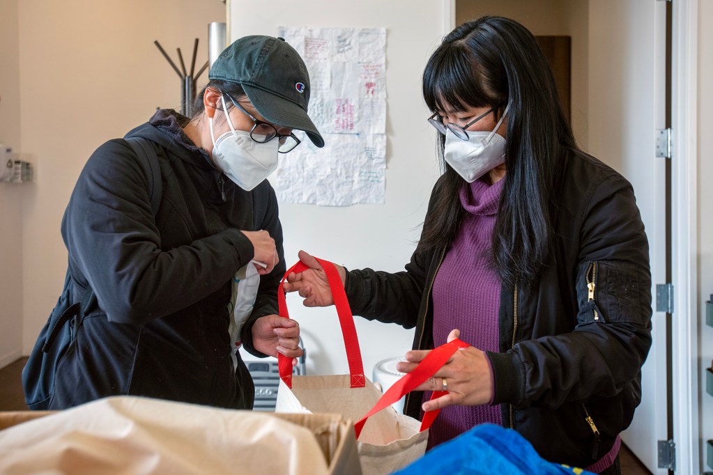 Annelisa Luong and CPA member leader Ai Lan Xie, prepare organization materials in San Francisco on Nov. 2, 2022. Photo by Mark Leong for CalMatters