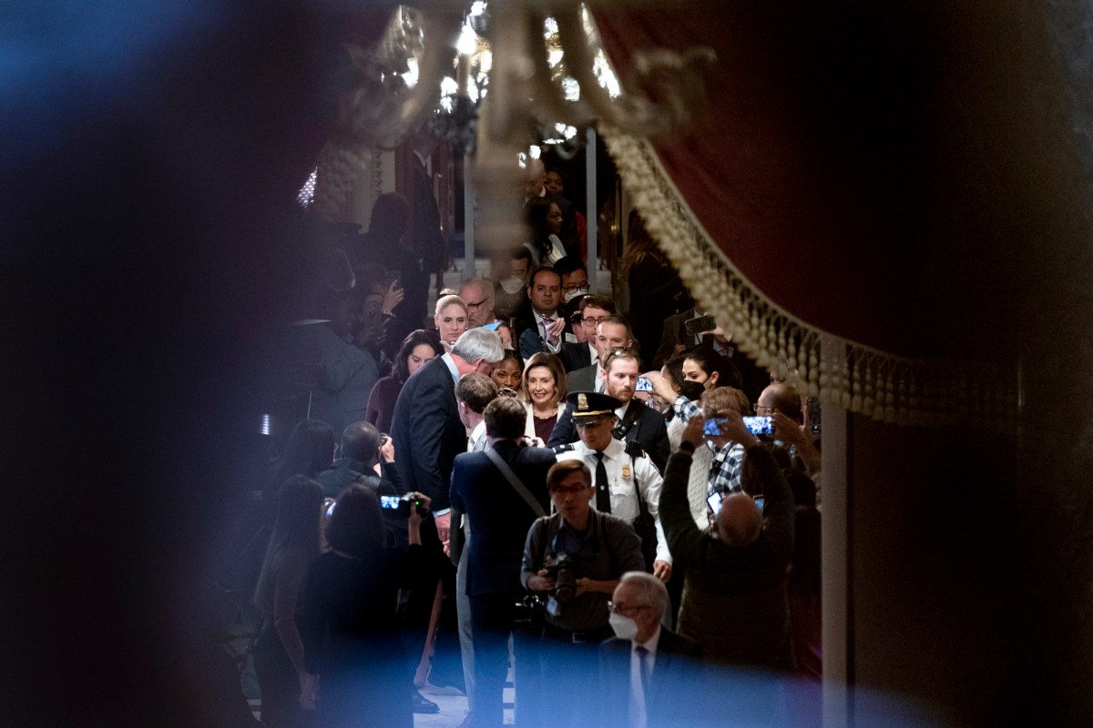 House Speaker Nancy Pelosi of Calif., center, is surrounded by members of the media as she heads back to her office after speaking on the House floor at the Capitol in Washington, DC, on Nov. 17, 2022. Photo by Andrew Harnik, AP Photo