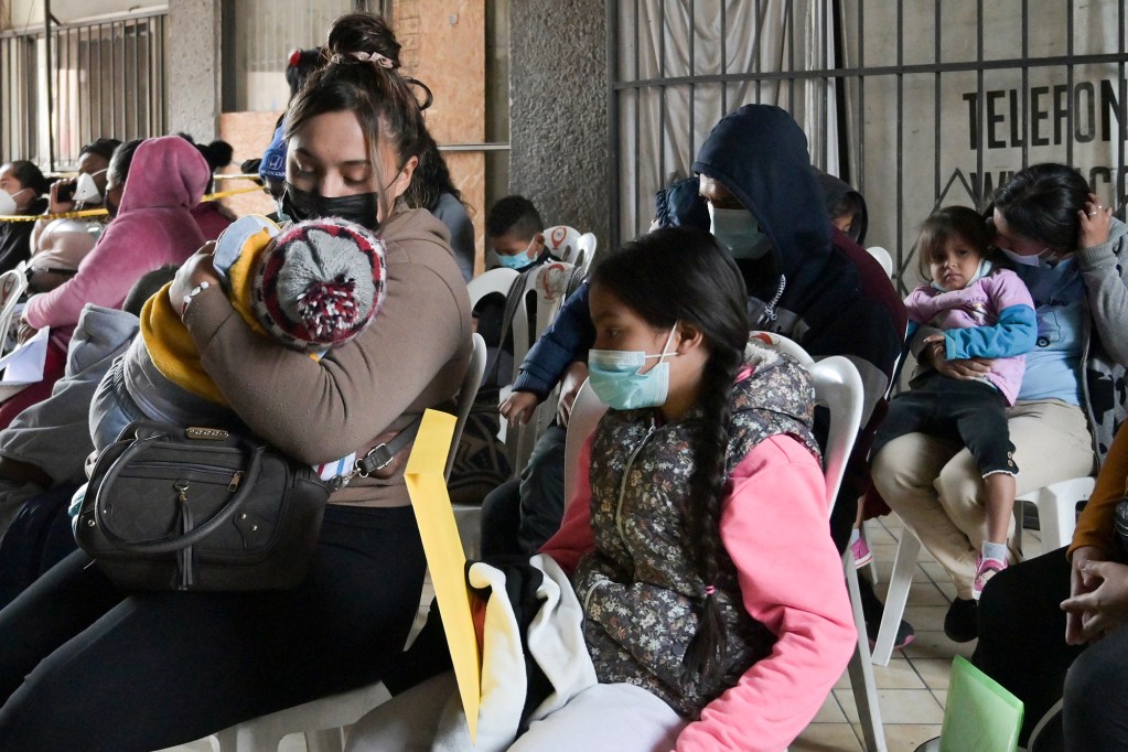 Migrants line up to get health services near the free non-profit clinic in Tijuana, Mexico on Dec. 22, 2022. Photo by Carlos A. Moreno for CalMatters