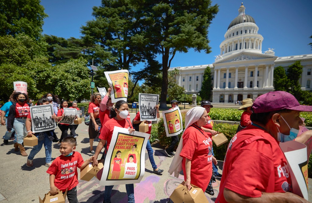 Fast-food workers and other SEIU members marched to the Capitol to deliver postcards and petitions in support of AB257 to the Governor's Office on May 31, 2022. Photo by Fred Greaves for CalMatters