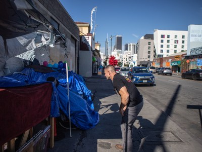 Physician assistant Brett Feldman speaks with a man in his encampment along Skid Row on Nov. 18, 2022. Photo by Larry Valenzuela for CalMatters