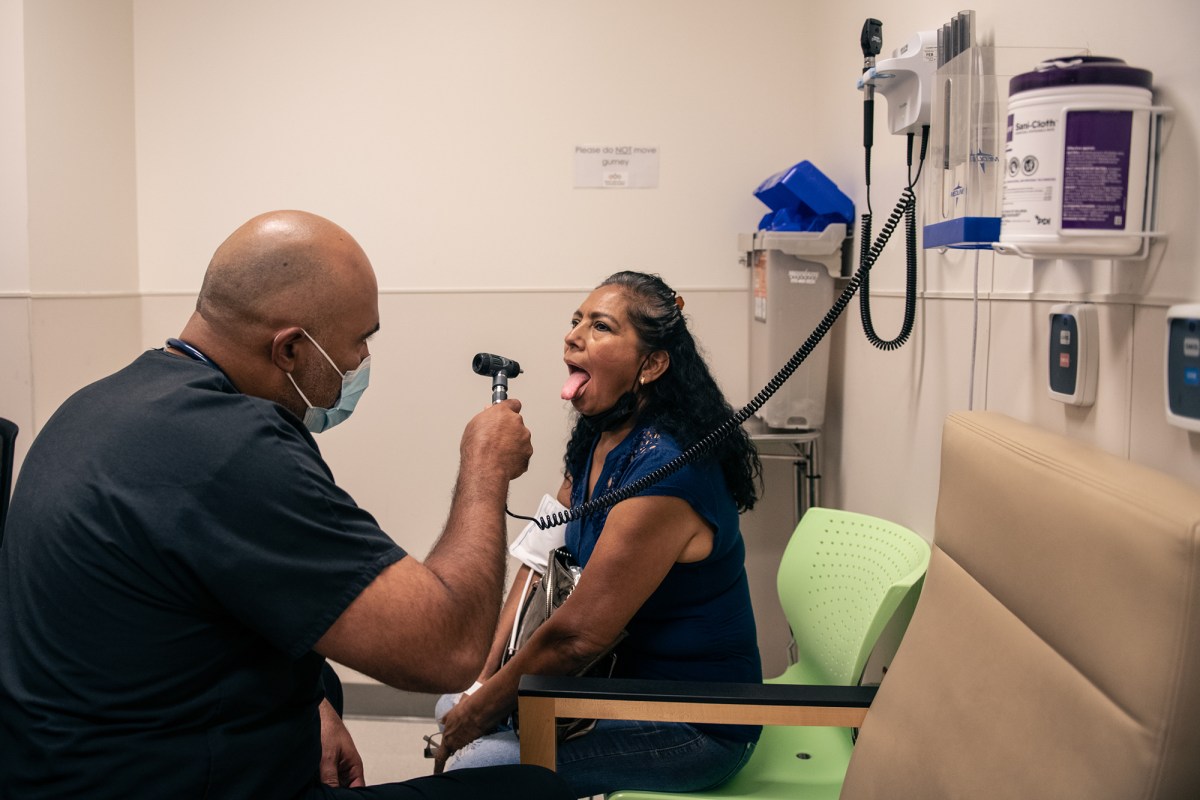 Elvia Macedo gets a medical check with Dr. Oscar Casillas at Martin Luther King Jr. Community Hospital in Los Angeles on July 26, 2022. Photo by Pablo Unzueta for CalMatters