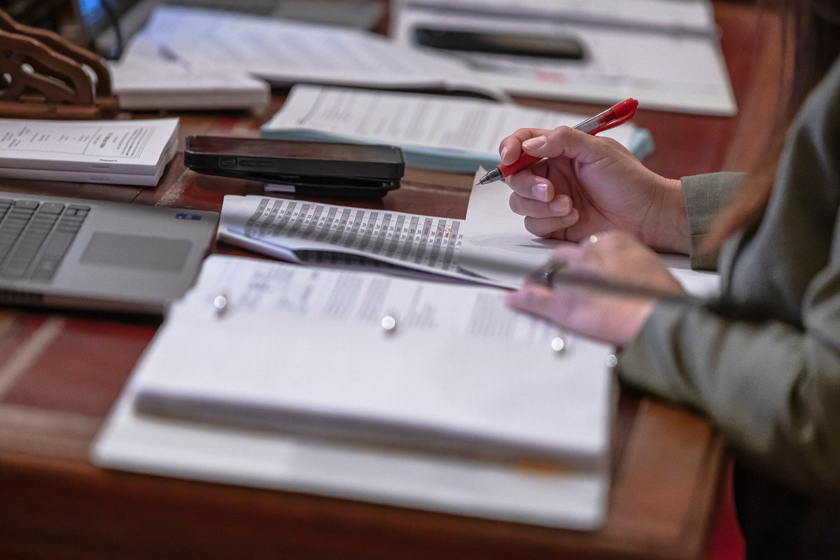 A state senator works during session on suspense file day at the state Capitol in Sacramento on Sept. 1, 2023. Photo by Rahul Lal for CalMatters