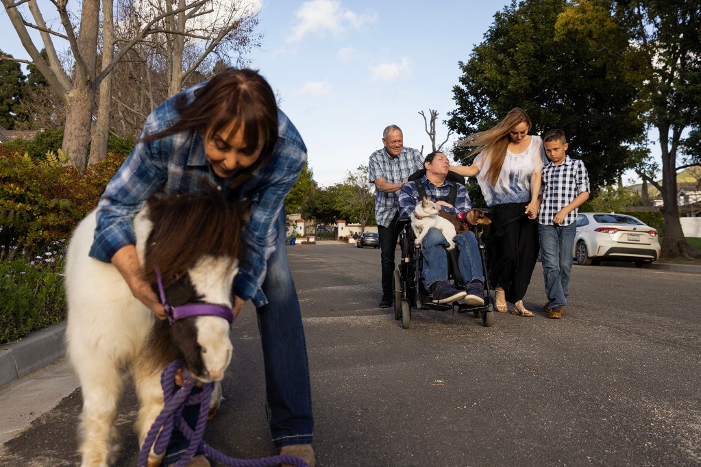 The Saeta family takes an evening walk together with Josh’s therapy animals at their home in Santa Rosa Valley, on March 11, 2024. Josh’s sister Jen said the family usually starts their neighborhood walks together once the weather begins to warm again. Photo by Alisha Jucevic for CalMatters