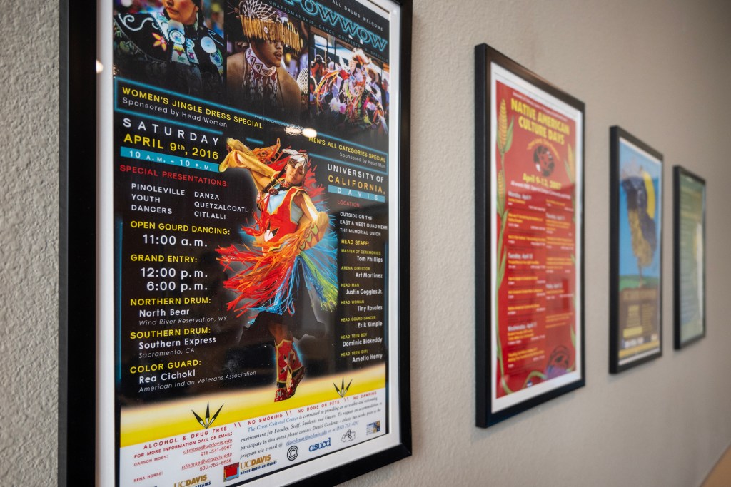 Posters of past Native American cultural events hang in the communal space at Yosemite Hall at UC Davis on April 1, 2024. Photo by José Luis Villegas for CalMatters