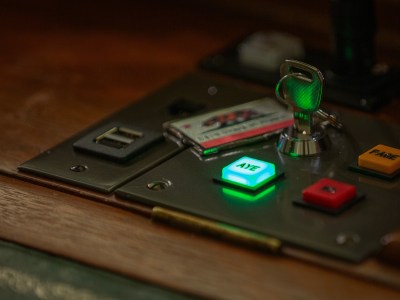 A close-up of a key with a California flag keychain on a voting panel with the "Aye" vote button lite up in green on a legislator's desk on the Assembly floor at the state Capitol in Sacramento on Aug. 17, 2023. Photo by Semantha Norris, CalMatters
