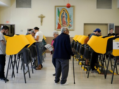 Rows of yellow voting marking devices while voters fill out their ballots at a polling place inside Assumption Church in the Boyle Heights neighborhood of Los Angeles on March 3, 2020. Photo by Kyle Grillot, Reuters